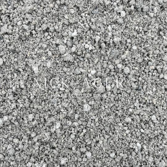 A close-up view of fine grey sand with various particle sizes, showcasing a uniform texture.
