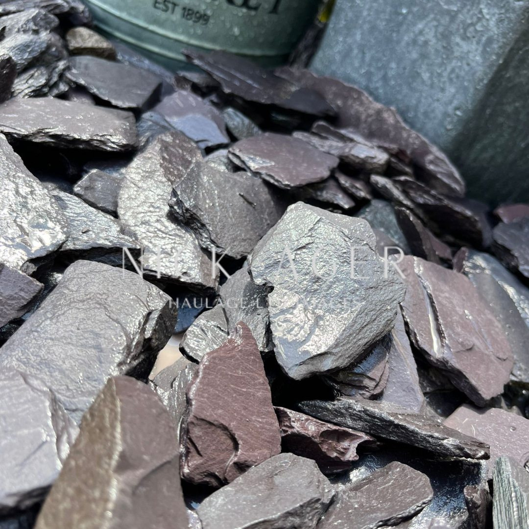 Close-up of various dark slate chippings, showcasing different textures and shades of purple and grey.