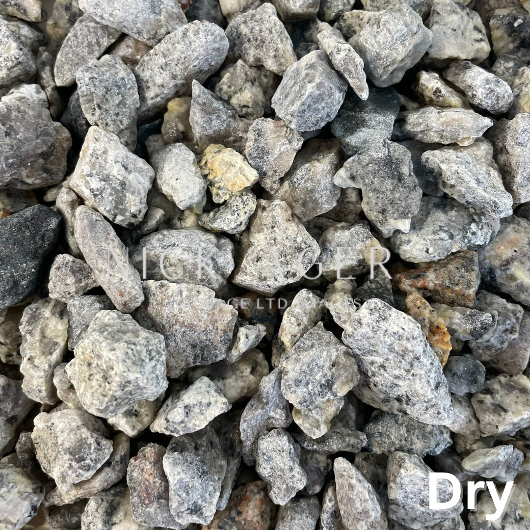 Close-up image of dry decorative gravel stones in various shades of grey and white