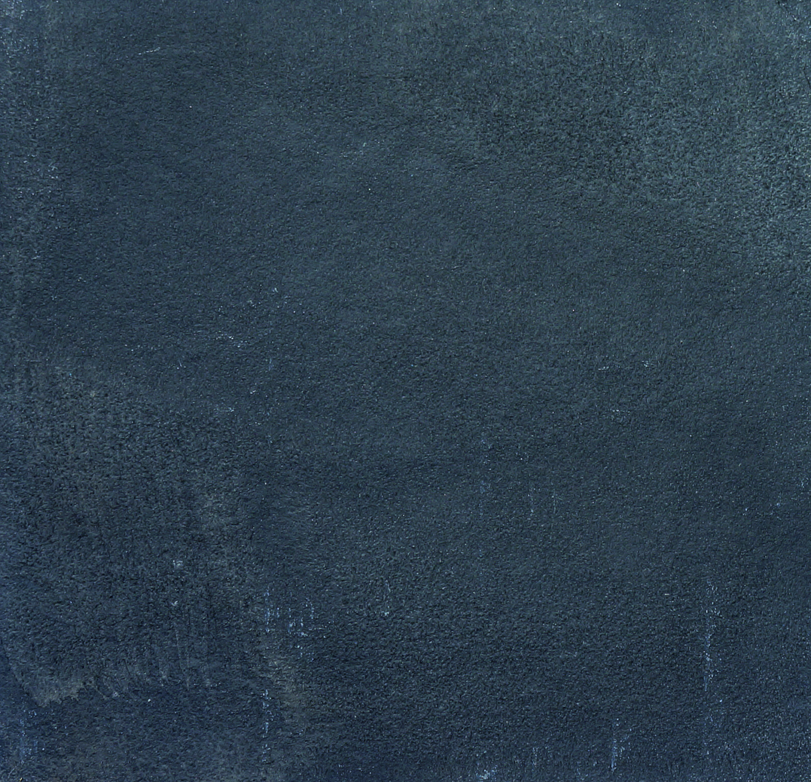 A dark textured surface featuring various shades of blue and subtle variations in texture.