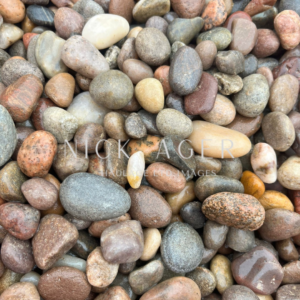 A close-up image of assorted smooth river stones in various shapes and colours, including shades of grey, brown, and tan.